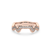 A rose gold band ring with a series of pave set diamonds creating a mountain range contour design.